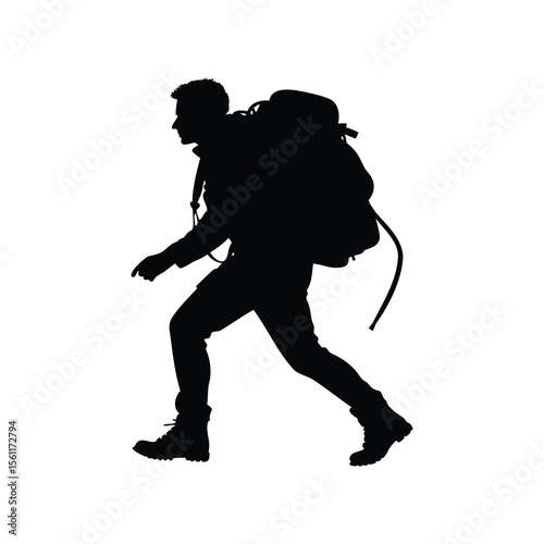 Silhouette of a determined hiker with a large backpack trekking uphill