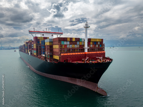 logistic cargo container ship sailing in sea to import export goods and distributing products to dealer and consumers across worldwide,