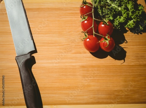 Cherry tomatoes and parsley on chopping board