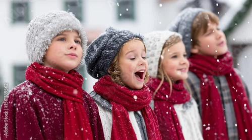 A group of Christmas carolers sings a festive holiday song in the cold winter season