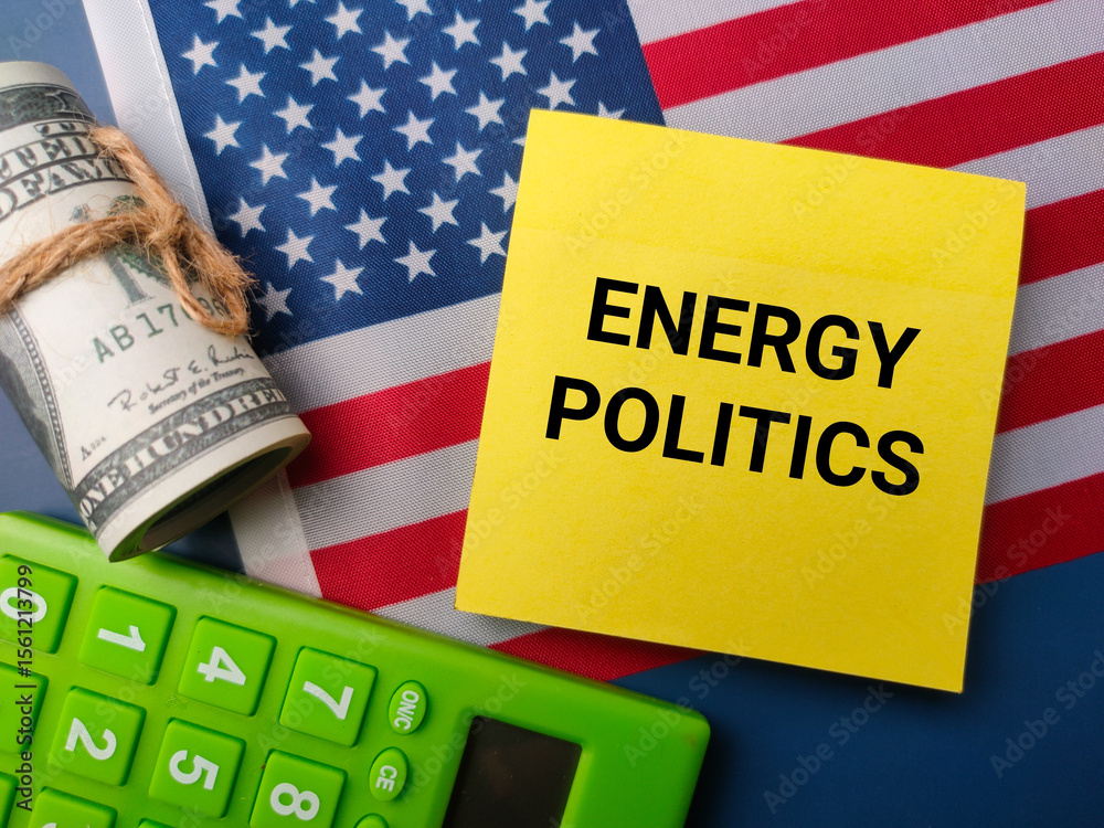 Fototapeta premium Top view banknotes and calculator with the word ENERGY POLITICS on a us flag background