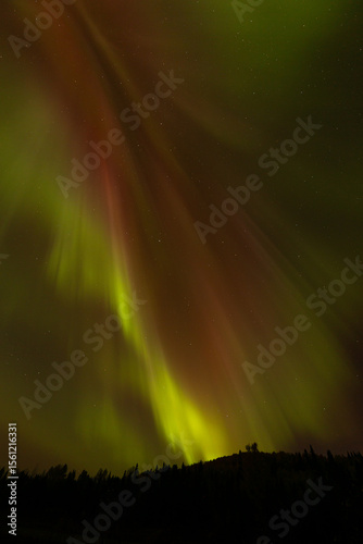 Spectacular displays of shimmering light from Aurora Borealis in the night sky. It was an amazing display of the Northern Lights