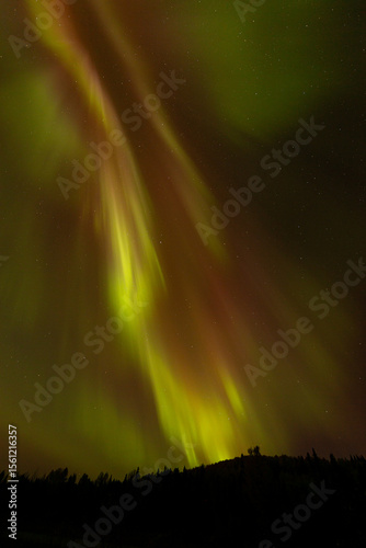 Spectacular displays of shimmering light from Aurora Borealis in the night sky. It was an amazing display of the Northern Lights