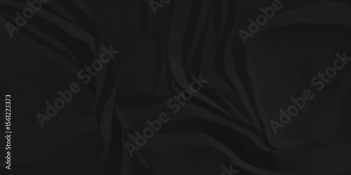 Dark black crumpled recycled craft paper texture background. Abstract blank background with space paper for text. Newspaper material wrinkled rough canvas paper texture.	