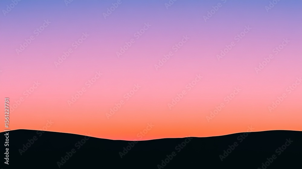 Fototapeta premium Silhouette of mountains against a vibrant sunset sky.