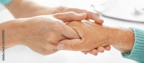 Doctor supporting elderly w...