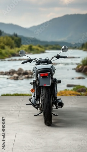 Mockup of a classic motorcycle parked beside a calm riverside landscape. Ideal for peaceful, nature-themed automotive presentations.