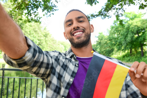 Young man with flag of Germ...