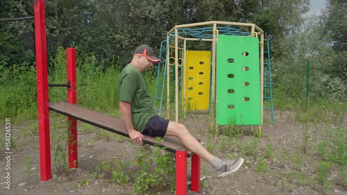 Active senior man exercising outdoors. Exercise for abdominal development.