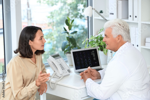 Senior doctor talking with ...