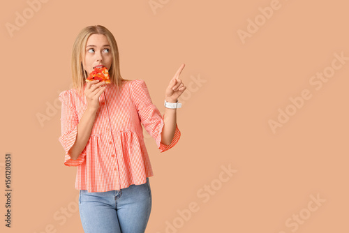 Young woman eating piece of...