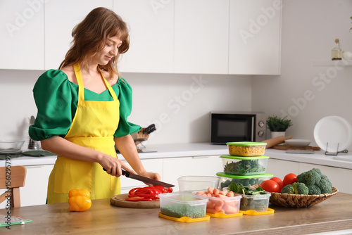 Young woman chopping fresh ...