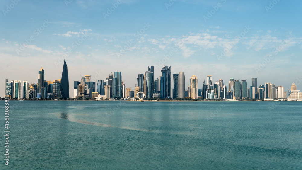 Fototapeta premium Panoramic view of the tall skyscrapers of Doha in Qatar. Persian Gulf countries. Doha skyline view with sea