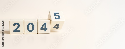 White cubes with changing numbers from 2024 to 2025 on a clean light background, symbolizing new year or future transition concept.