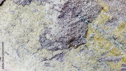 Close-up of a natural mountain rock surface featuring rough and organic textures. Ideal for use in backgrounds, design elements,
