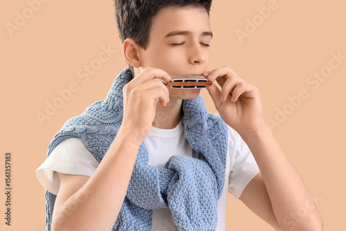 Teenage boy playing harmoni...