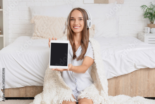 Young woman in headphones w...