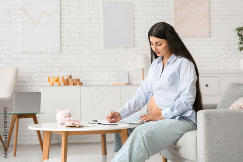 Young pregnant woman using ...