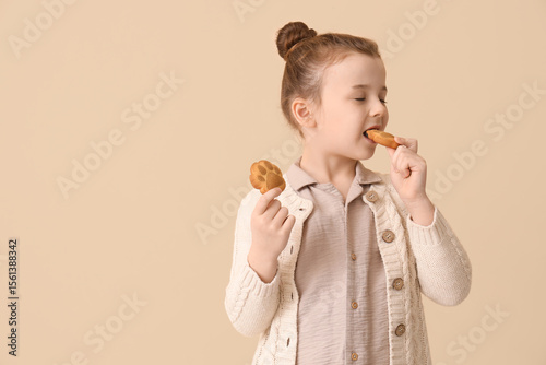 Little girl eating cookies ...