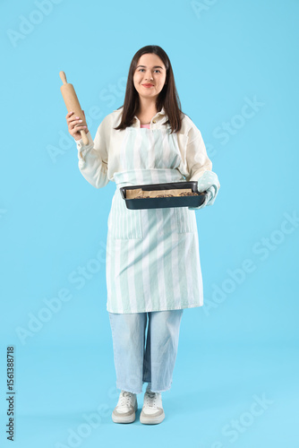Young woman baker holding r...