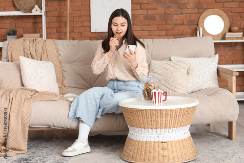 Young woman with mobile pho...