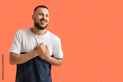 Thankful young man pressing...