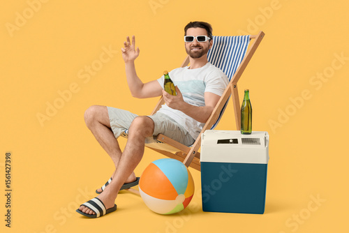 Happy young man sitting on ...