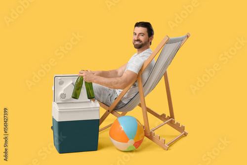 Happy young man sitting on ...