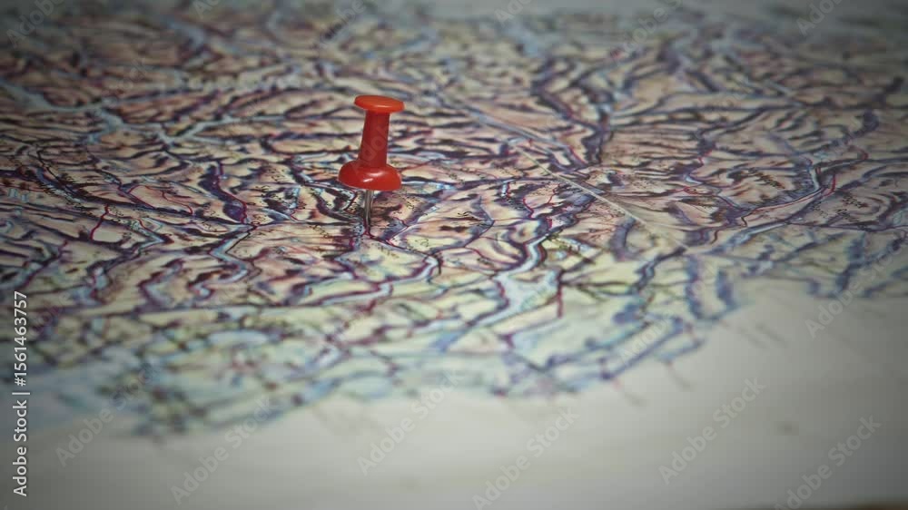 Hand places Coloured Pin on regional route map in Norwegian Fjords