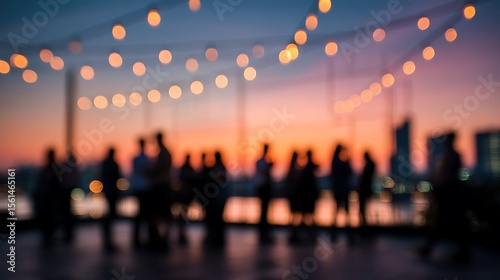 Fototapeta Naklejka Na Ścianę i Meble -  Rooftop party with string lights and silhouettes of people against a colorful sunset sky