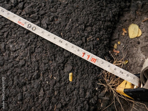 measurement of the width of the asphalt road which shows the width is 11 meters
