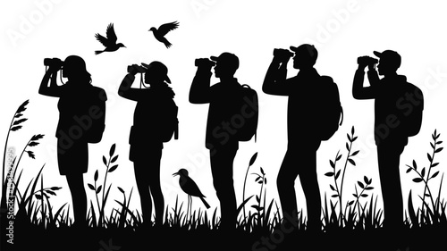 Group of birdwatchers with binoculars observing nature and birds in silhouette