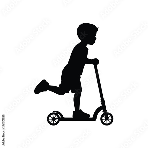Silhouette of a young boy riding a scooter with one leg pushing off the ground