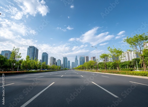 High-speed highway, an asphalt road with trees and buildings in the background. The wide-open plain is empty of cars on an early summer day. In the front view, white lines mark the right side for driv