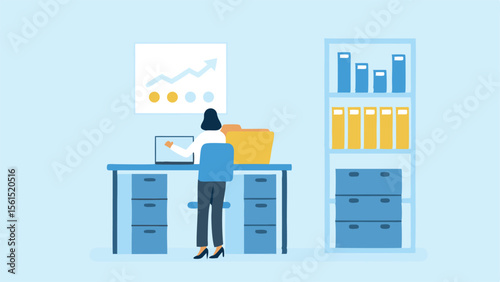Woman working at desk with laptop and chart in office with shelves and filing cabinets visible