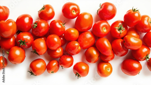 Cherry Tomatoes on White. A top-down view features a scattering of bright red cherry tomatoes, some with green stems still attached, against a clean white background. 