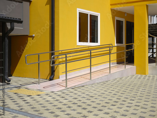 Close-up of wheelchair ramp at the entrance of a residential building.
