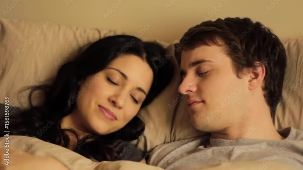 Intimate moments: Couple sharing a quiet morning in bed with soft sunlight Intimate moments: Couple sharing a quiet morning in bed with soft sunlight