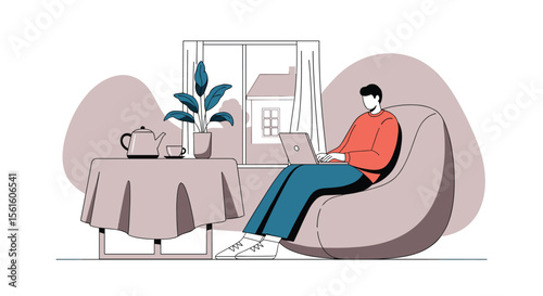 Young man working on laptop while sitting in beanbag chair near window with plant and table