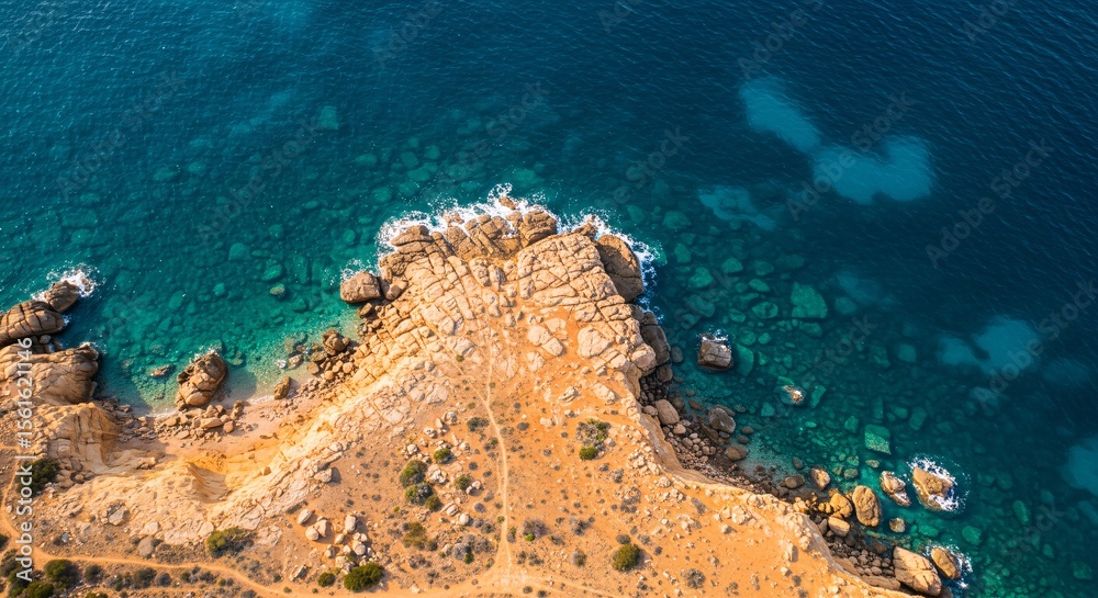 Obraz premium Aerial view of rocky coastline with clear turquoise water in Cyprus landscape