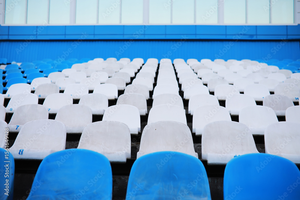 Naklejka premium Plastic chairs in the stands of a sports stadium. Cheer on the stands of the stadium.