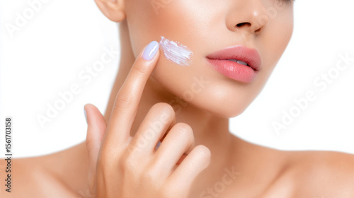 Soft skin care cream on finger near lips shows makeup tutorial for smooth glowing face with natural beauty and gentle touch