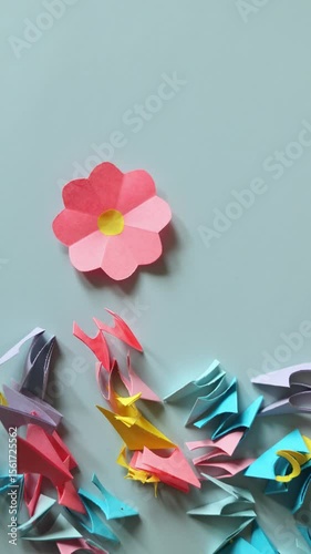 summer paper craft for kids. create art for children bouquet of flowers for mother's day. scraps of colored paper on pink background.