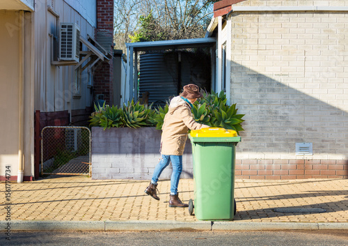 Putting rubbish bin out on the street