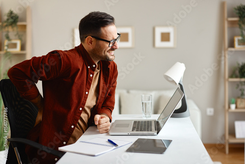 Freelancer experiencing back pain while working from home