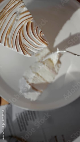 eating a slice of delicious cake with white cream