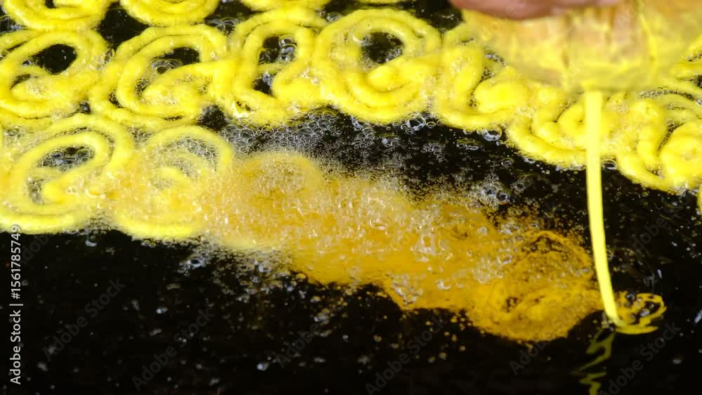 Jalebi is a famous indian sweet. frying sweets jalebi in oil, indian, Bangali and pakistani dessert mithai, Spiral crunchy candies fried in oil