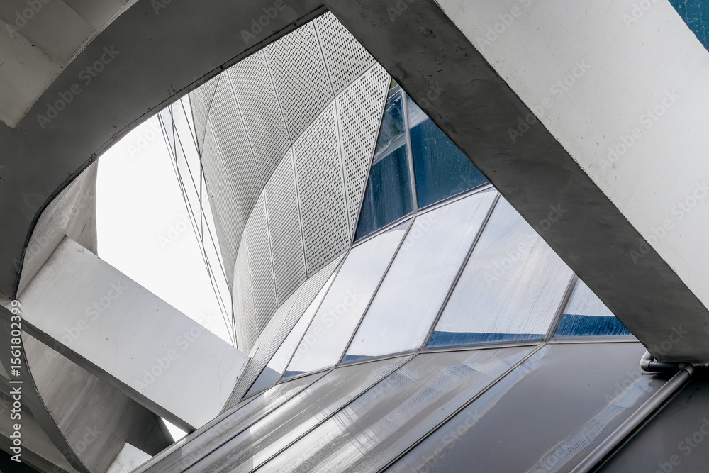 Fototapeta premium Futuristic urban architecture with geometric steel and glass elements