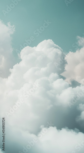 Soft white clouds float gently in a clear blue sky during a calm afternoon in summer