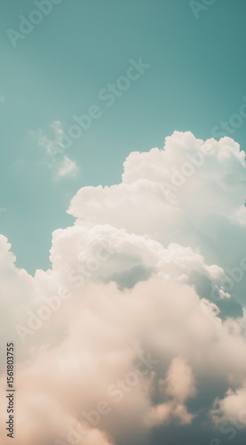 Soft white clouds float against a clear blue sky in a serene atmosphere during midday